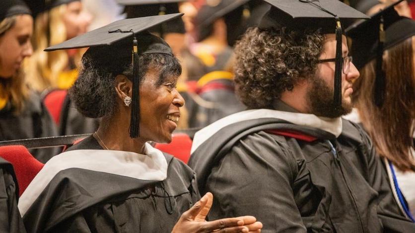 Students sitting in crowd during commencement ceremony